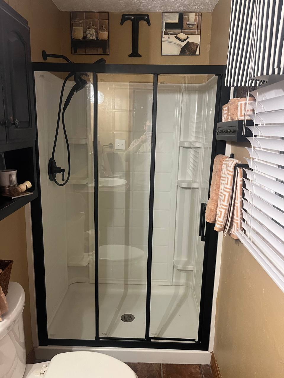 Shower with new black-framed glass sliding door