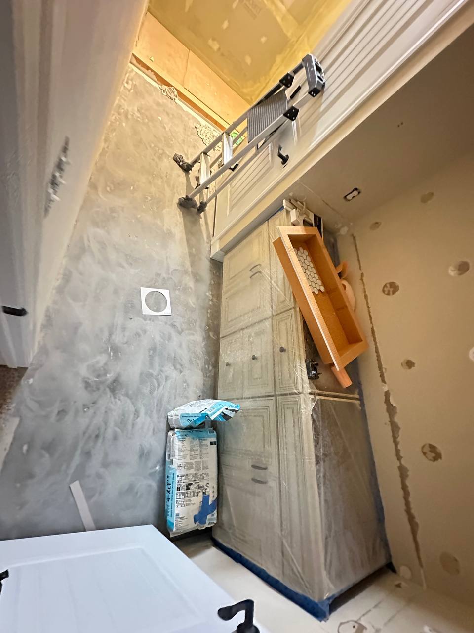 Bathroom remodel preparation with protected cabinets