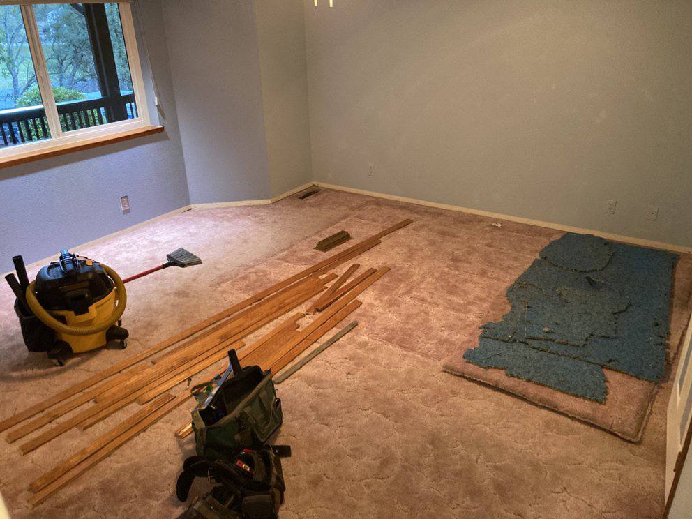 Old carpet removal and flooring prep in progress