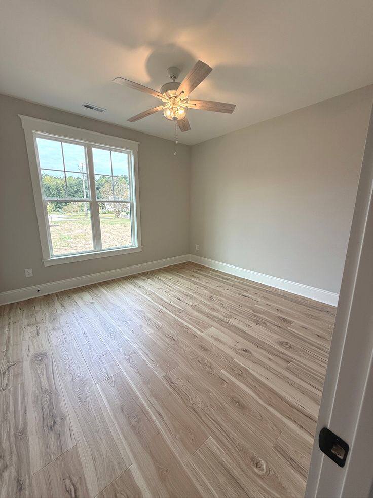 Bedroom with light-tone laminate flooring