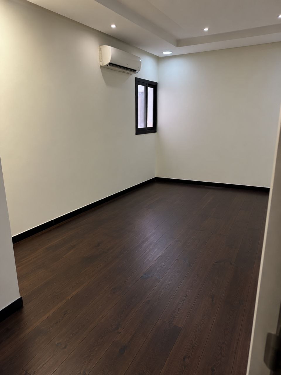 Room with new dark wood-tone flooring