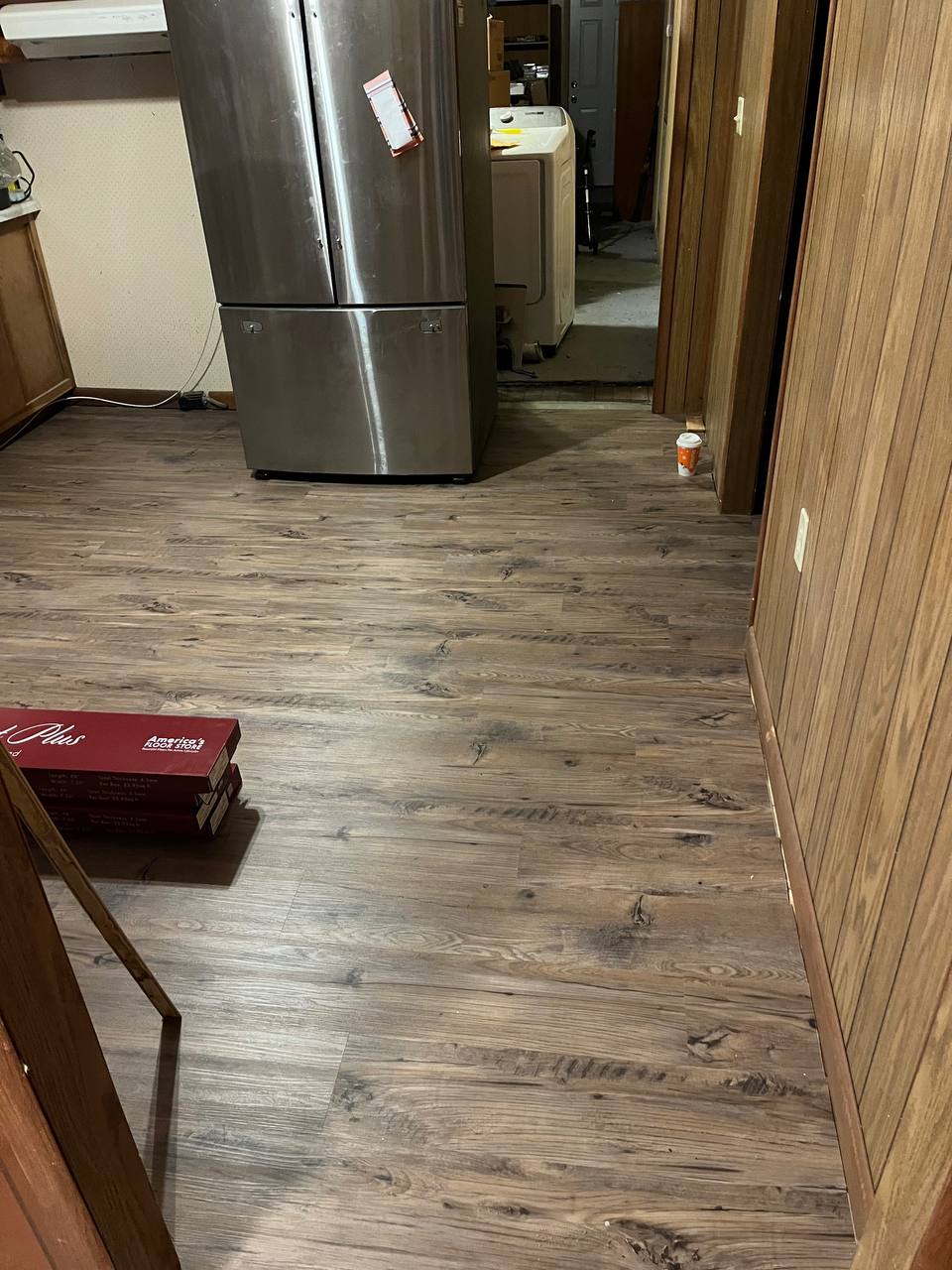 Flooring installation in progress with new material boxes